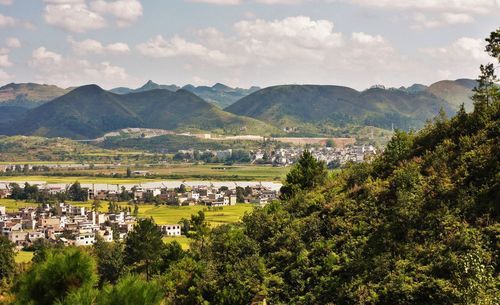 View of village against cloudy sky