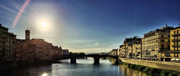 Bridge over river with buildings in background