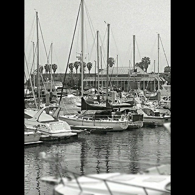 nautical vessel, water, boat, transportation, moored, mode of transport, mast, harbor, sea, waterfront, sailboat, transfer print, reflection, auto post production filter, sky, in a row, outdoors, travel, day, clear sky