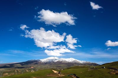 Scenic view of mountains against blue sky