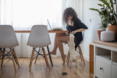 Woman sitting on chair at home