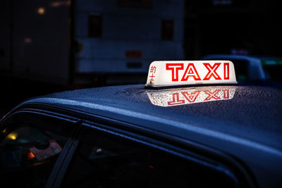 Illuminated taxi text on car
