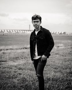 Portrait of young man standing on field