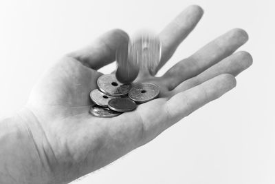 Close-up of person holding hands over white background