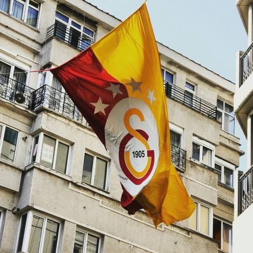 building exterior, architecture, low angle view, built structure, flag, outdoors, day, no people, city, yellow, sky