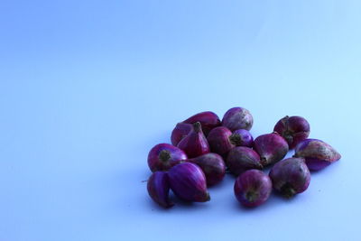 Close-up of berries over white background