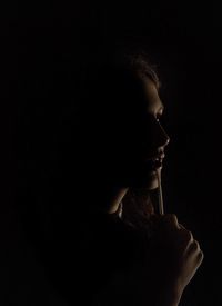 Close-up of thoughtful woman in darkroom