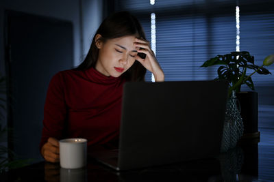 Young woman using laptop at home