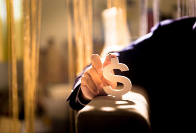 Close-up of hand holding illuminated lighting equipment