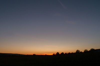 Silhouette landscape against sky during sunset