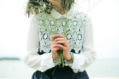 Close-up of woman holding plant