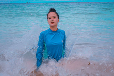 Portrait of young woman swimming in sea