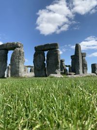 View of stone wall on field against sky