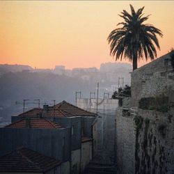 Buildings against sky at sunset