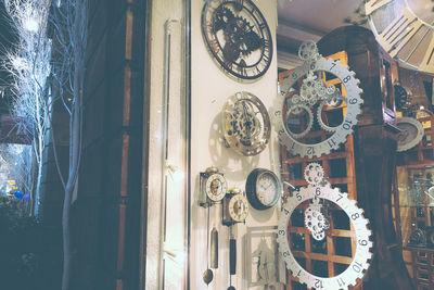 Close-up of clock hanging on glass window