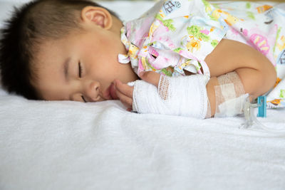 Baby girl sleeping on bed