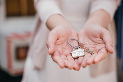 Midsection of woman holding key ring
