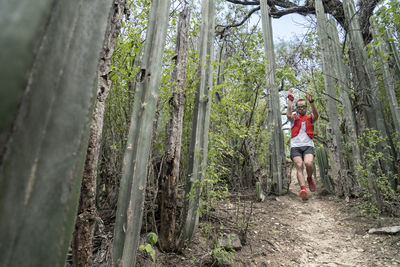 One man running on a narrow trail between many cactus in san sebastian