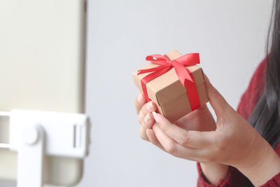 Cropped hand of woman holding gift box