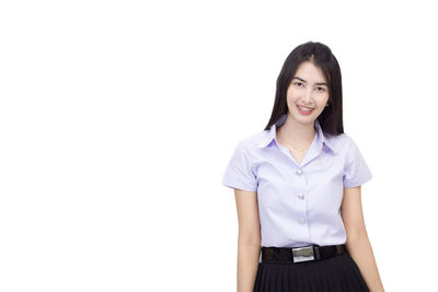 Portrait of smiling young woman against white background