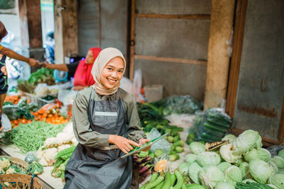 Portrait of woman selling vegetables at market