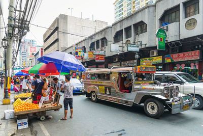 People in city street during rainy season