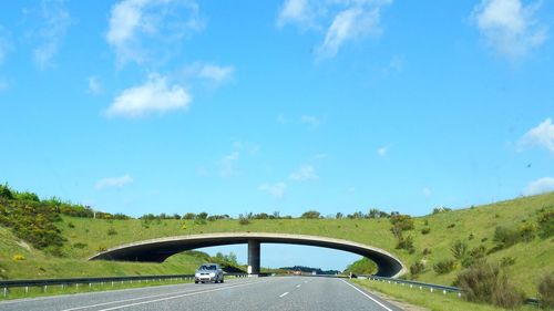 Road against blue sky seen through car windshield