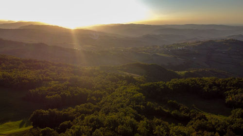 Aerial view from the drone of hills around little city of serramazzoni, modena, italy, during sunset