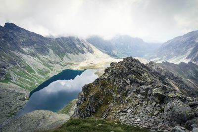 Scenic view of mountains against cloudy sky