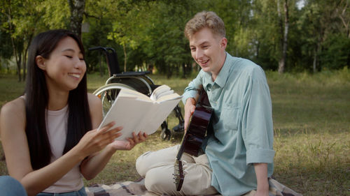 Portrait of smiling friends standing in park