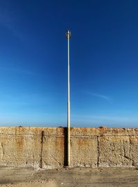 Low angle view of street light against blue sky