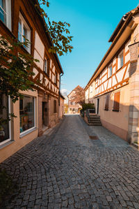 Footpath amidst buildings in city