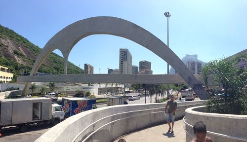 People walking on arch bridge