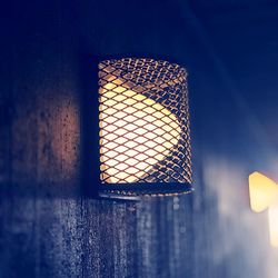 Close-up of illuminated light against wall