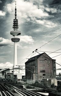 Railroad track against cloudy sky