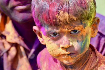 Portrait of boy covered in paint