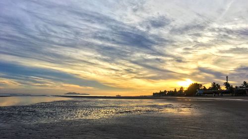 Scenic view of beach against sky during sunset