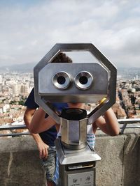 Mid adult man photographing cityscape against sky