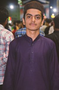 Portrait of young man in traditional clothing standing outdoors