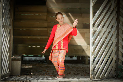 Full length of woman standing on steps