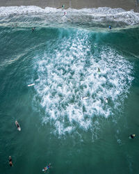 High angle view of people swimming in sea