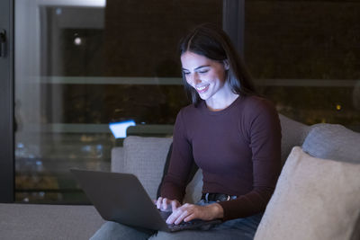 Young woman using laptop at home