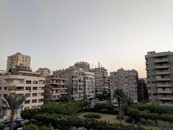 Buildings in city against clear sky