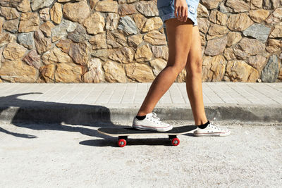 Low section of woman on skateboard