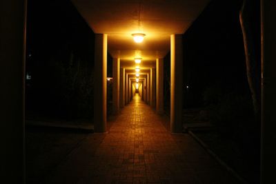 Empty road in illuminated tunnel