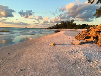 Scenic view of beach against sky during sunset