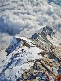 Scenic view of snowcapped mountains against cloudy sky