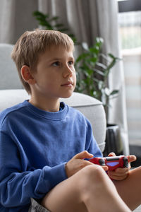 Portrait of cute boy using mobile phone