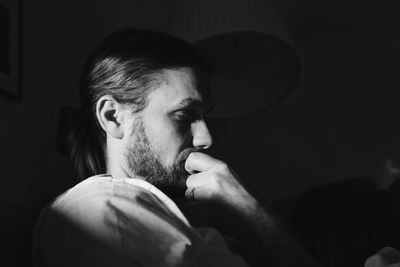 Thoughtful young man looking down