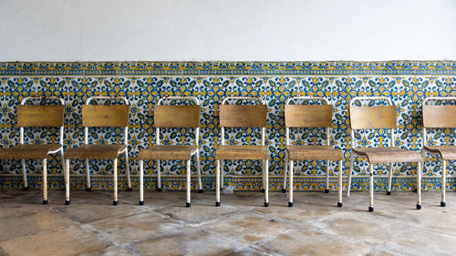 Empty chairs against wall